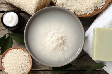 Flat lay composition with soaked rice on wooden table