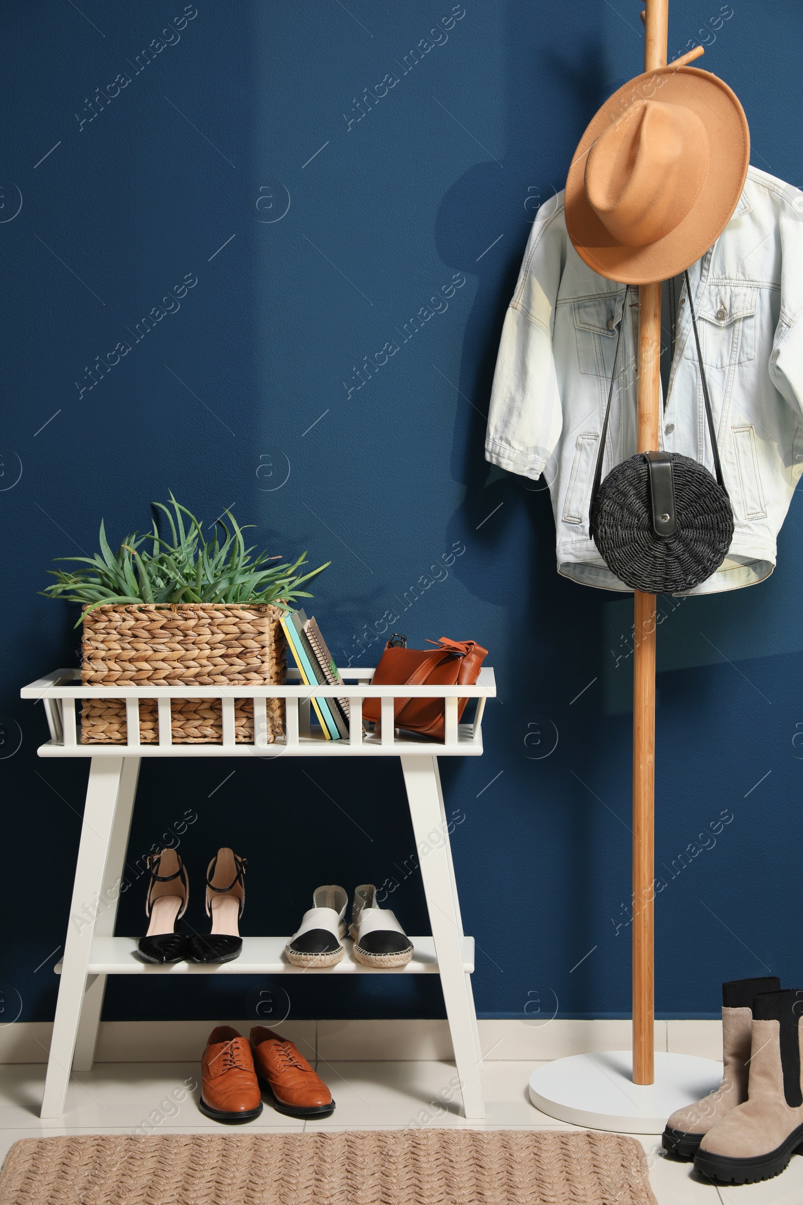 Photo of Hallway interior with stylish furniture, clothes and accessories