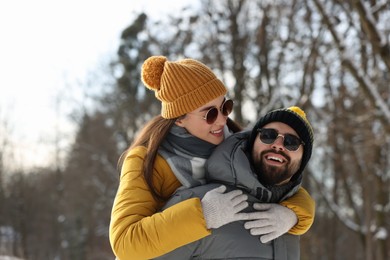 Happy young couple having fun outdoors on winter day
