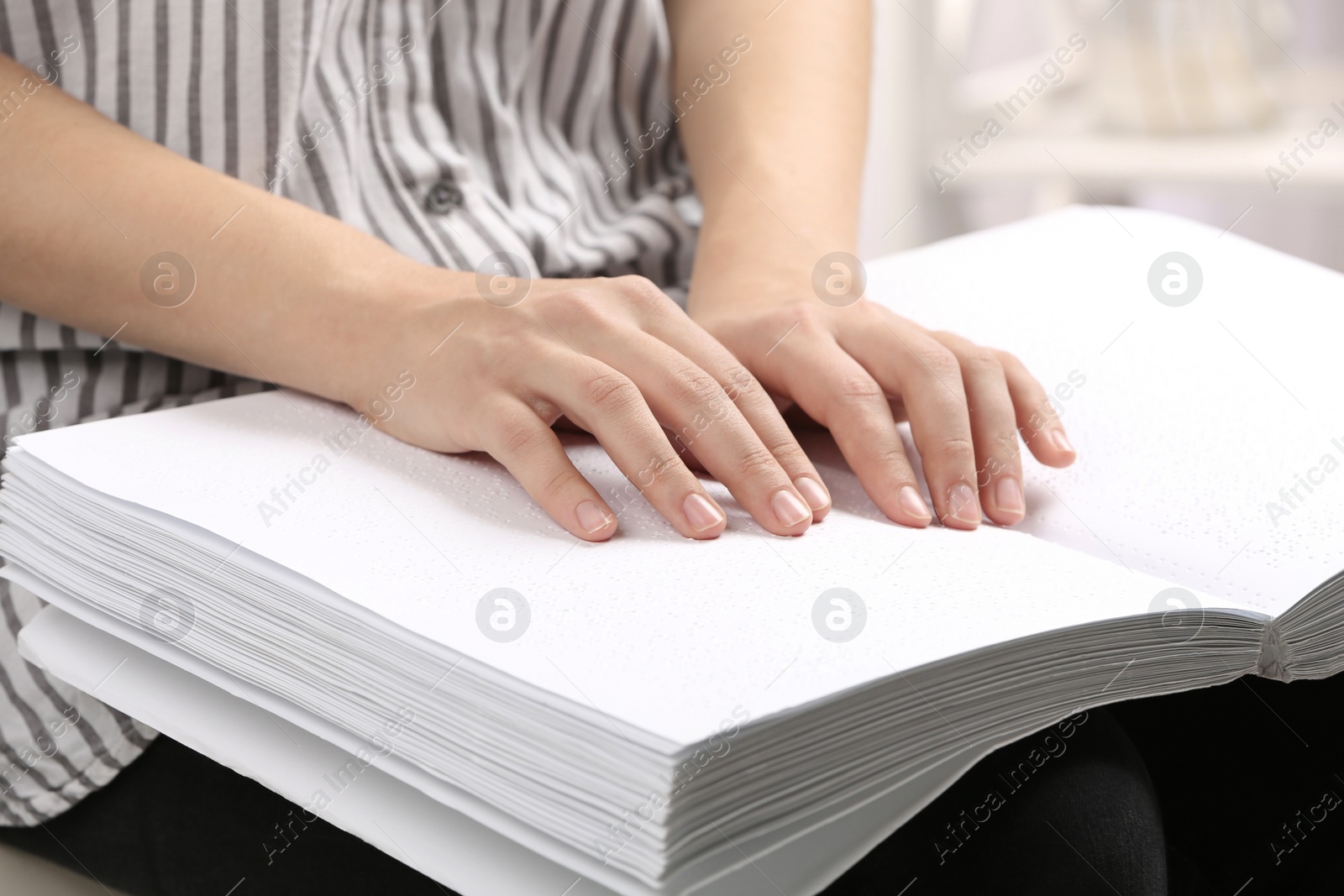 Photo of Blind person reading book written in Braille, closeup