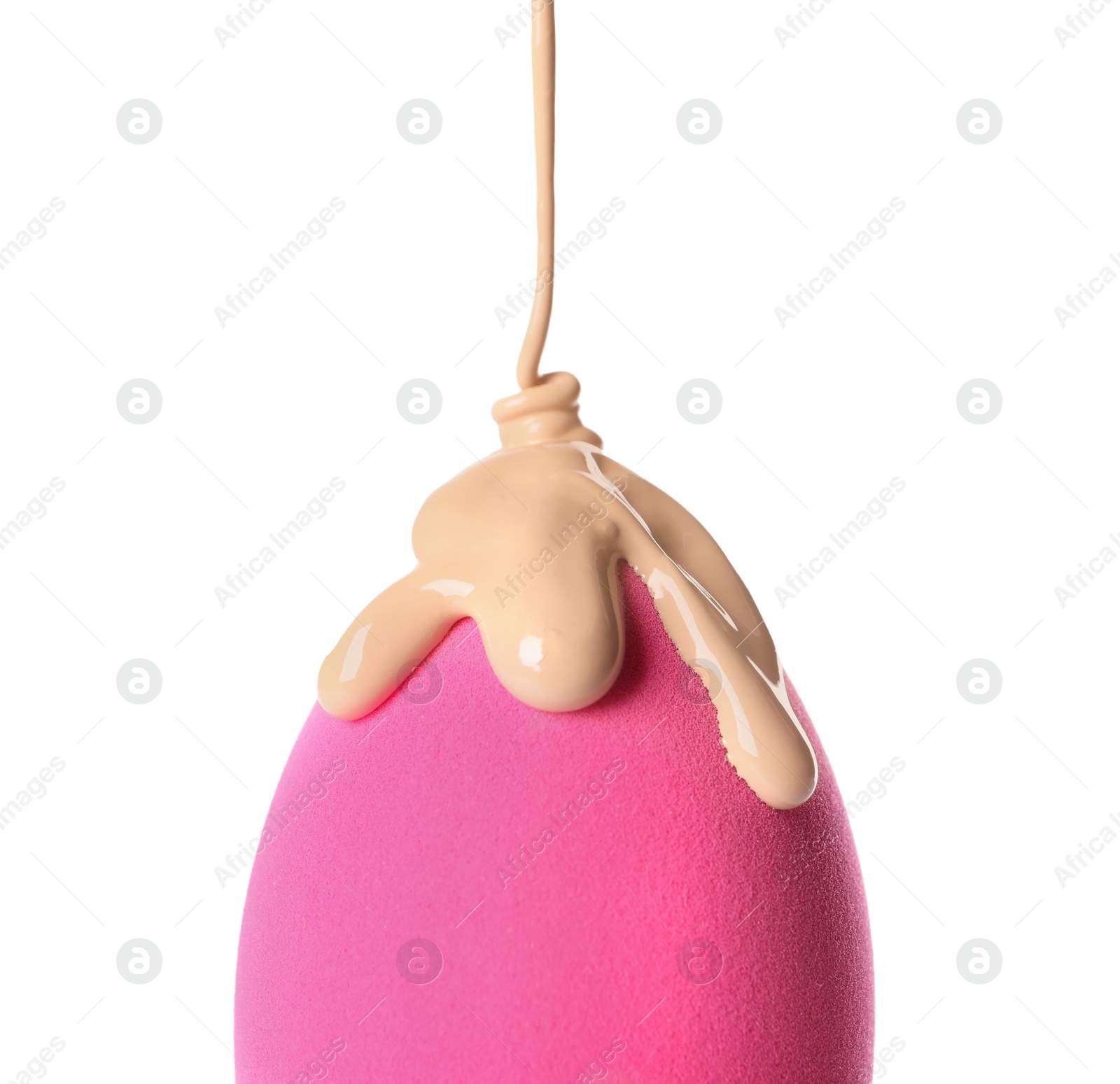 Photo of Pouring skin foundation onto makeup sponge on white background