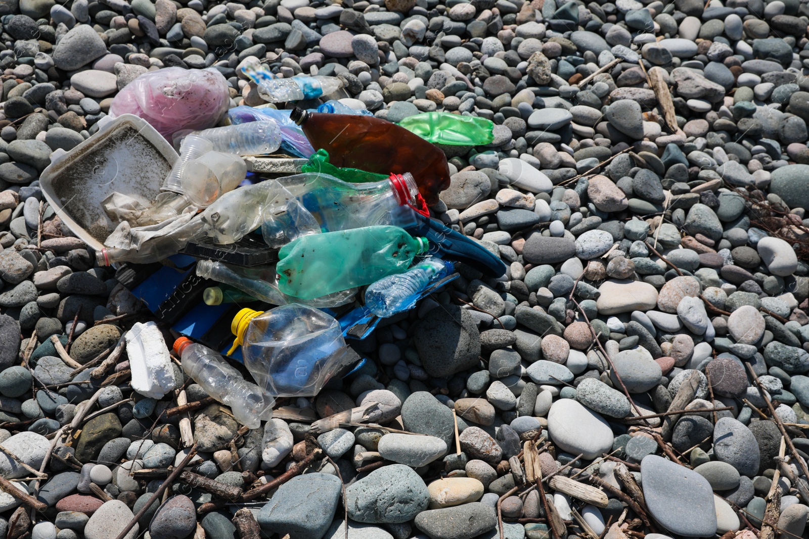 Photo of Pile of garbage on stones outdoors. Environmental Pollution concept