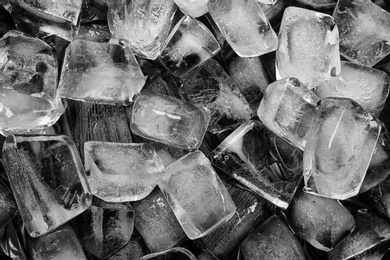 Photo of Many ice cubes on black background, top view