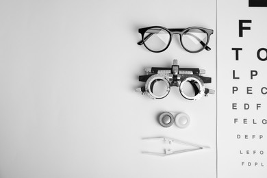 Photo of Different ophthalmologist tools on white background, flat lay