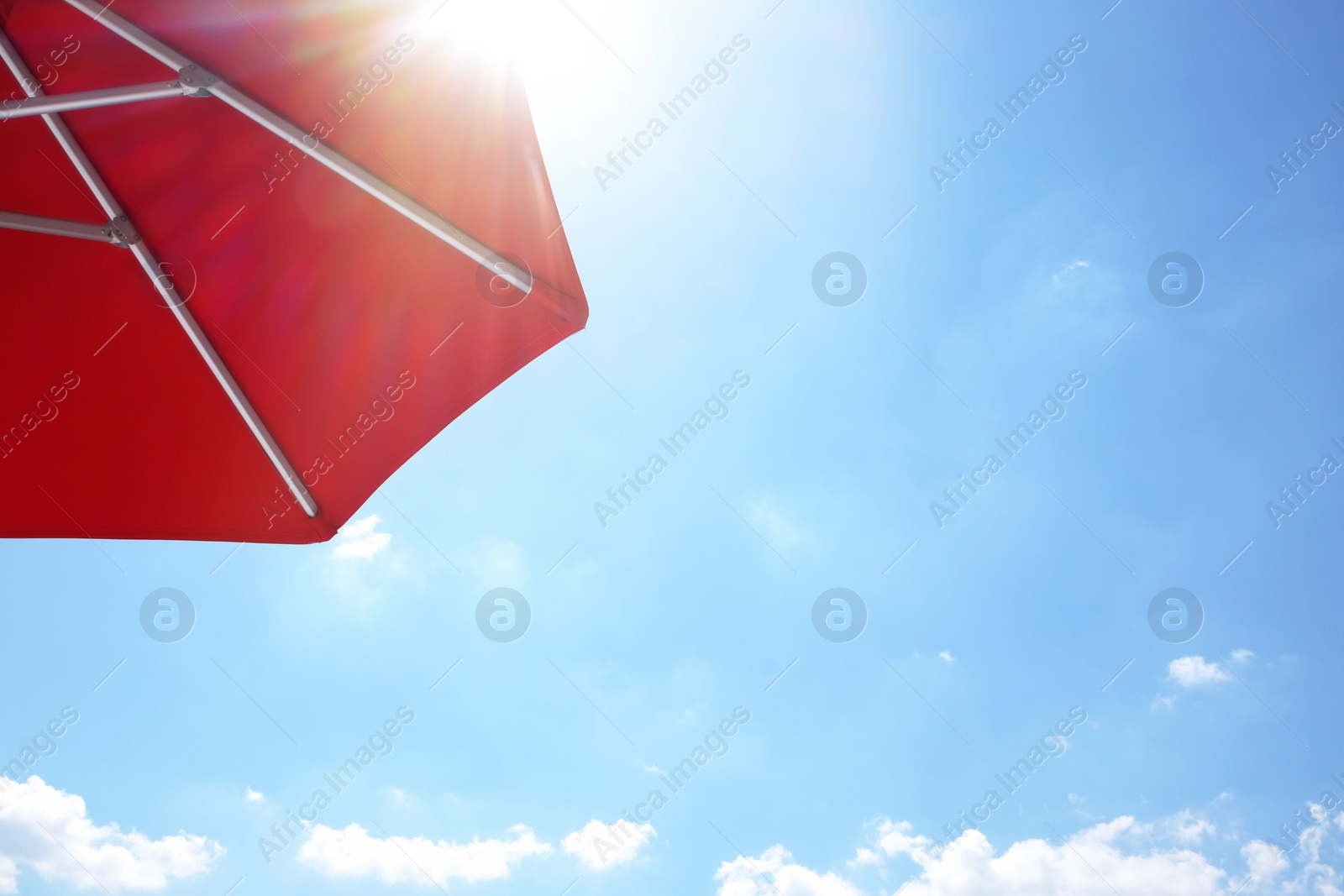 Photo of View of red umbrella and blue sky on sunny day