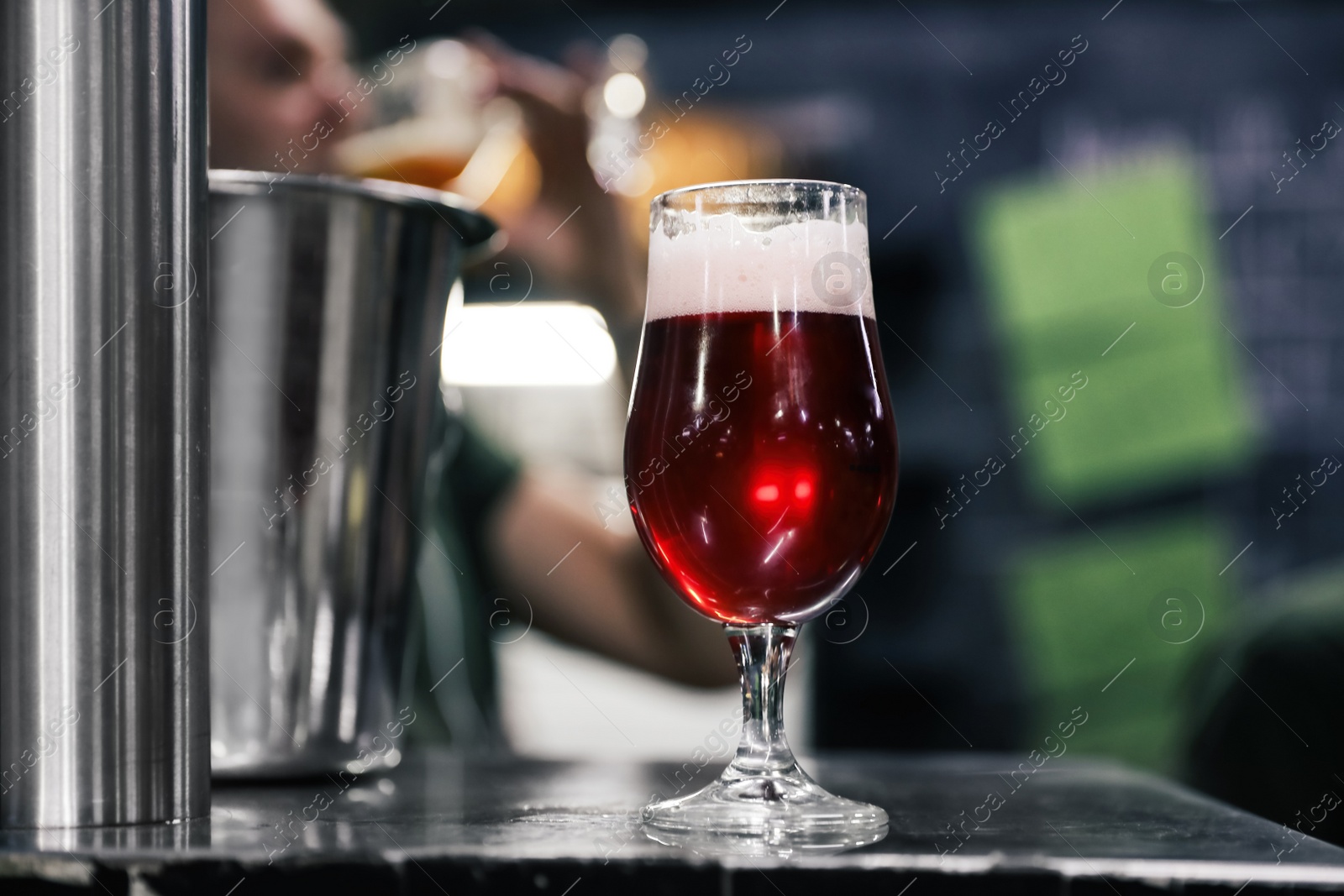 Photo of Glass of beer on bar counter in pub