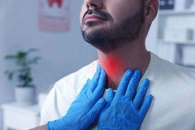 Image of Endocrinologist examining thyroid gland of patient at hospital, closeup