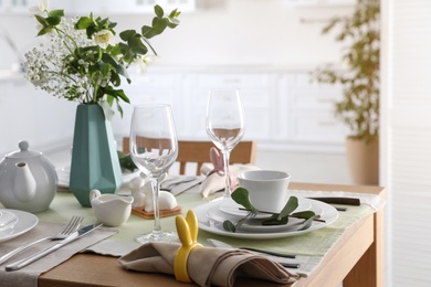 Photo of Beautiful Easter table setting with festive decor indoors