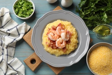 Photo of Plate with fresh tasty shrimps, bacon, grits and green onion on light blue wooden table, flat lay