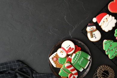 Delicious Christmas cookies on black table, flat lay with space for text