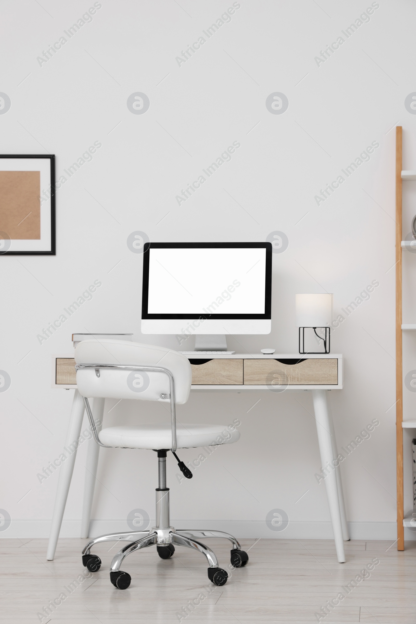 Photo of Workplace with comfortable office chair indoors. Interior design