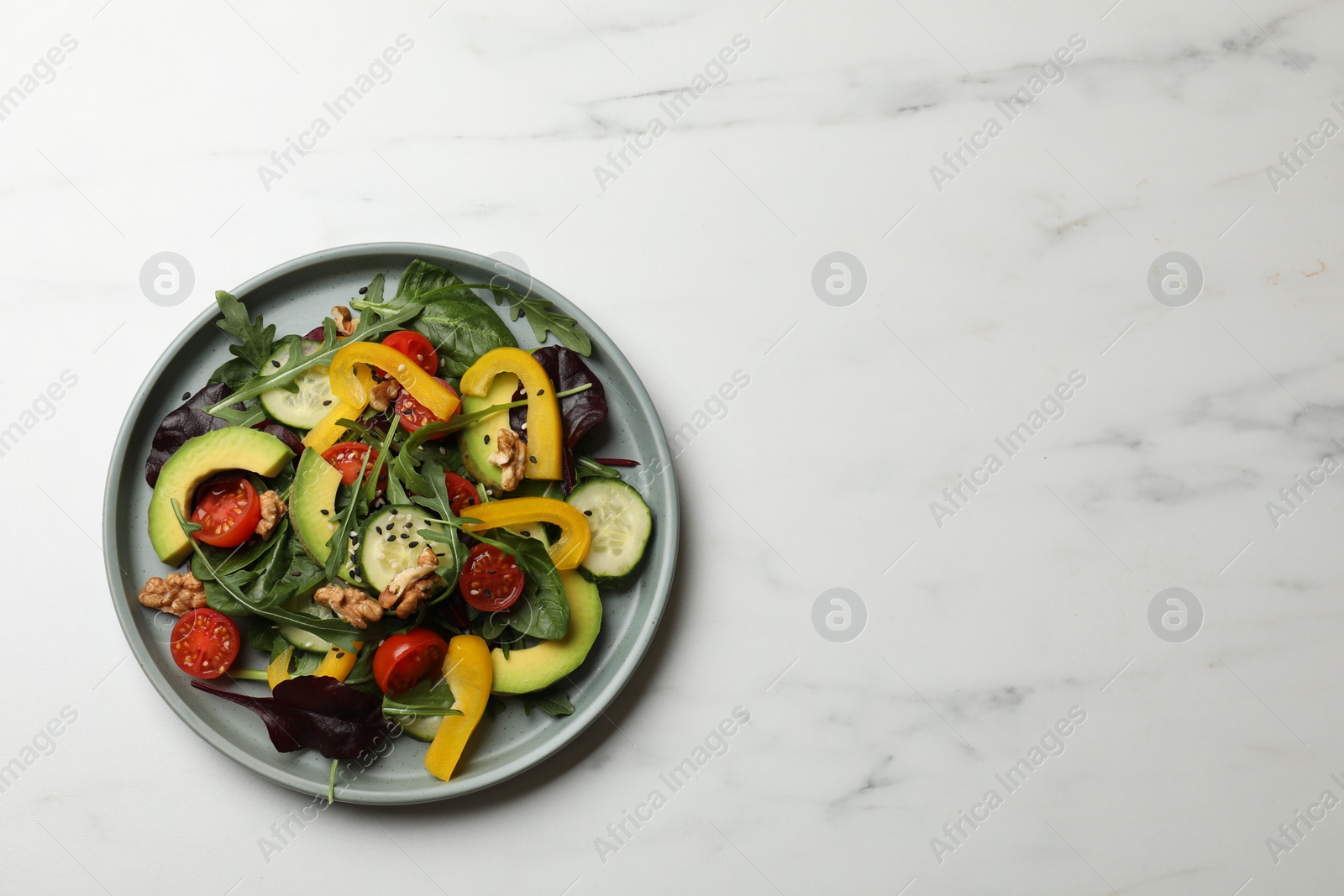 Photo of Balanced diet and vegetarian foods. Plate with different delicious products on white marble table, top view. Space for text