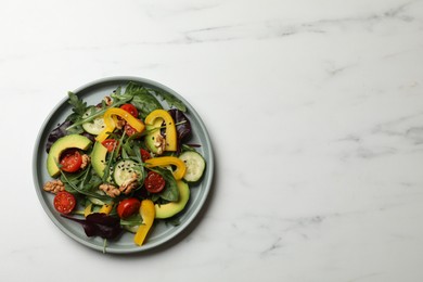 Balanced diet and vegetarian foods. Plate with different delicious products on white marble table, top view. Space for text