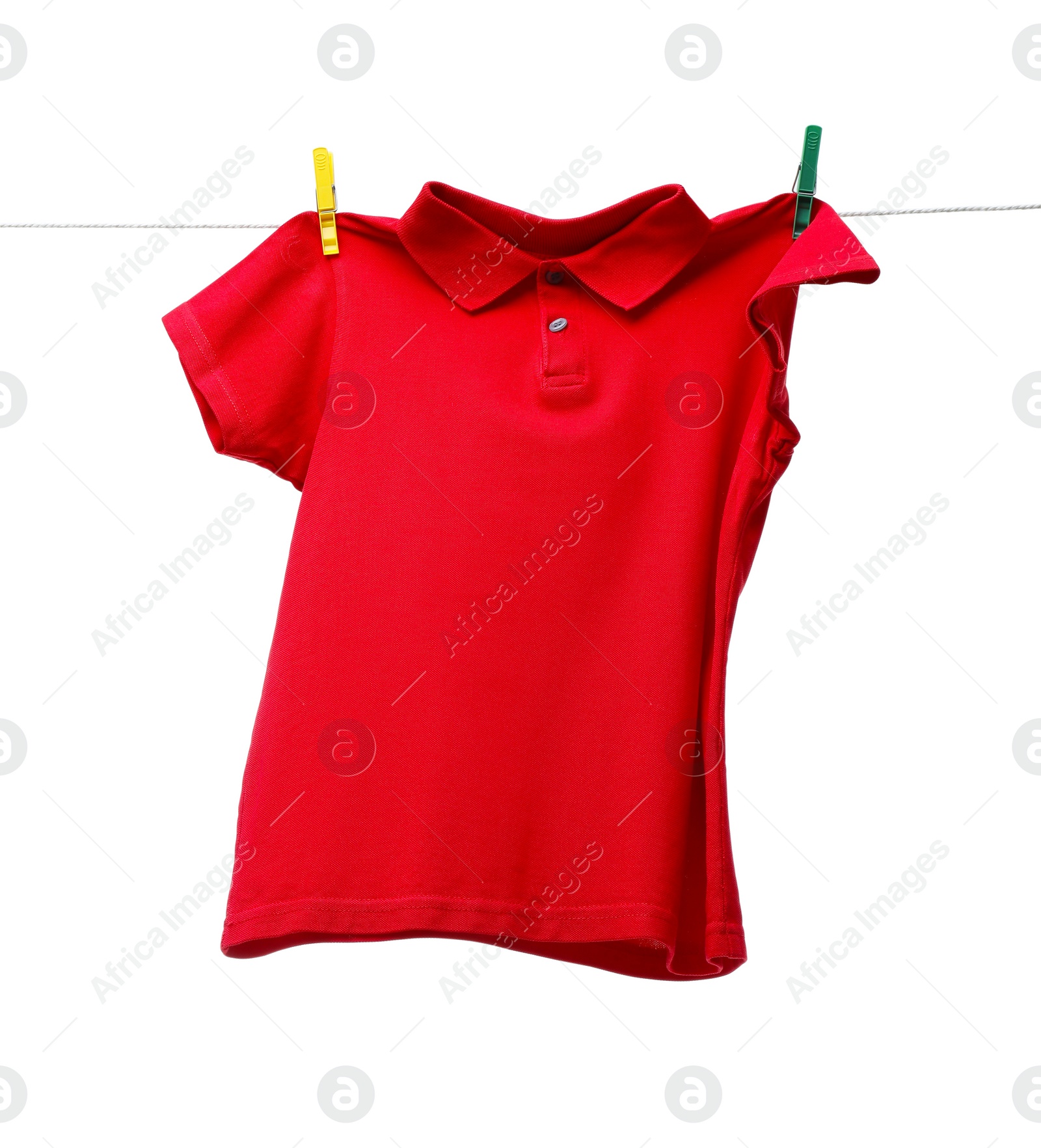 Photo of One red t-shirt drying on washing line isolated on white