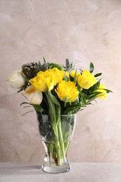 Photo of Beautiful bouquet with peony tulips on table against grey background