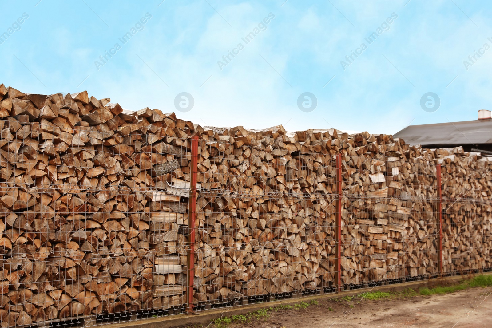 Photo of Stacked firewood outdoors. Heating house in winter