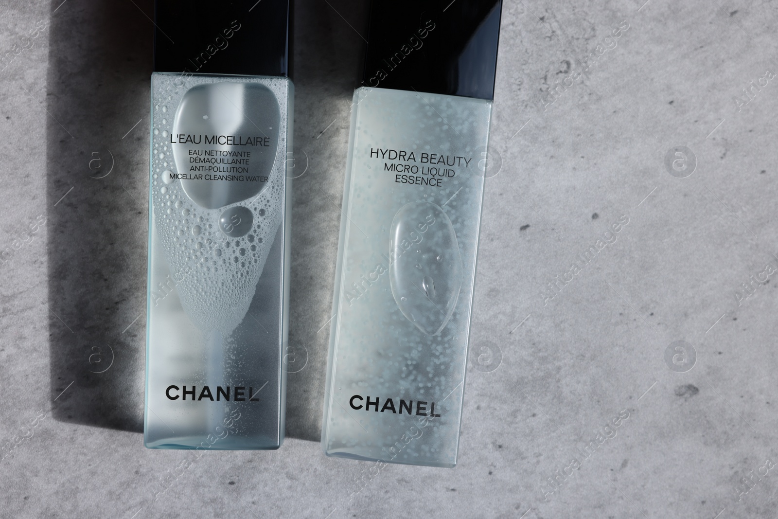 Photo of Leiden, Netherlands - July 14, 2022: Chanel cosmetic products on light grey table, flat lay. Space for text