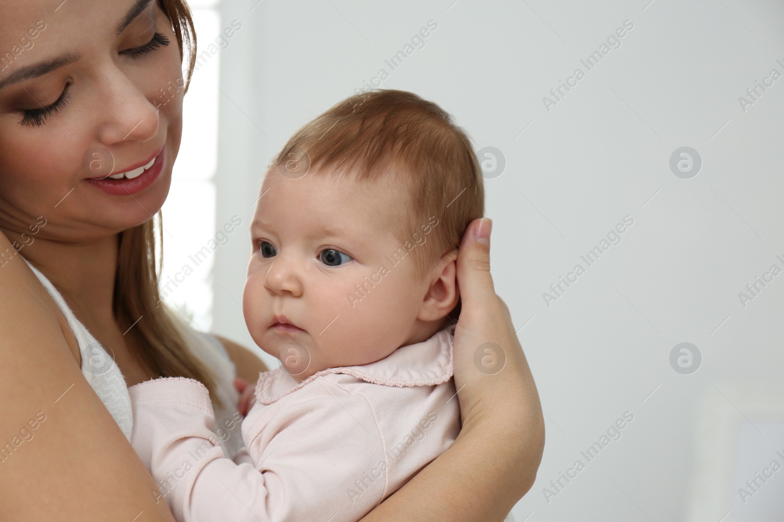 Photo of Young woman with her little baby resting after breast feeding at home