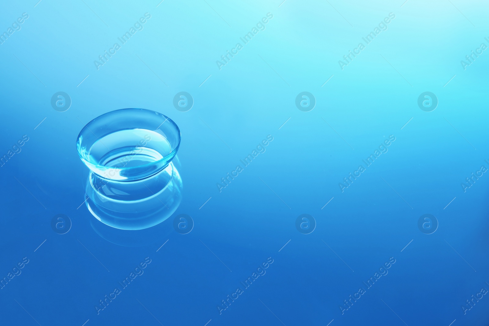 Photo of Contact lens on color glass background