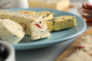 Photo of Different types of tasty butter served on white table, closeup