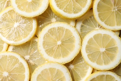 Slices of fresh lemons as background, top view