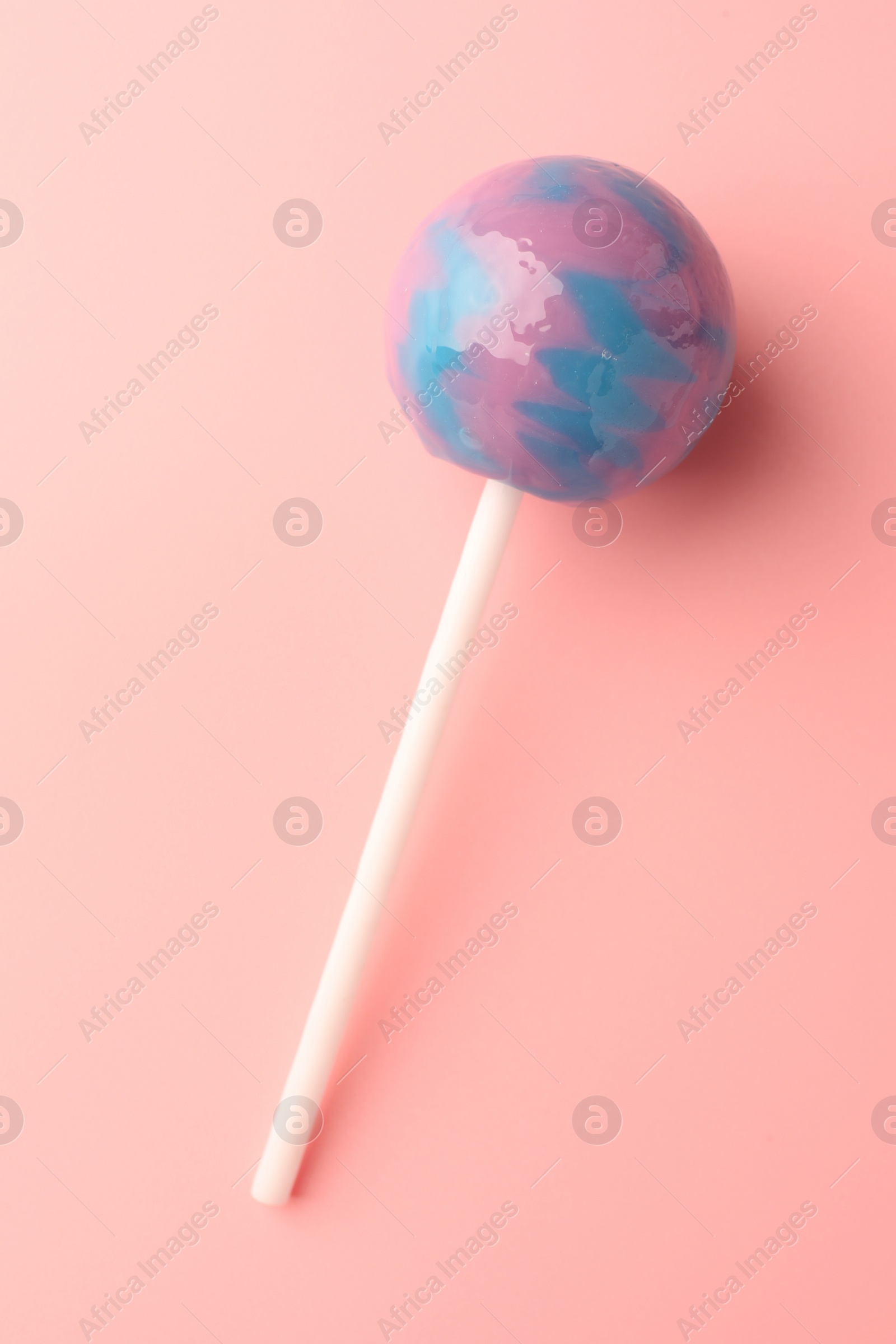 Photo of Tasty lollipop on pink background, top view