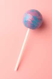 Tasty lollipop on pink background, top view