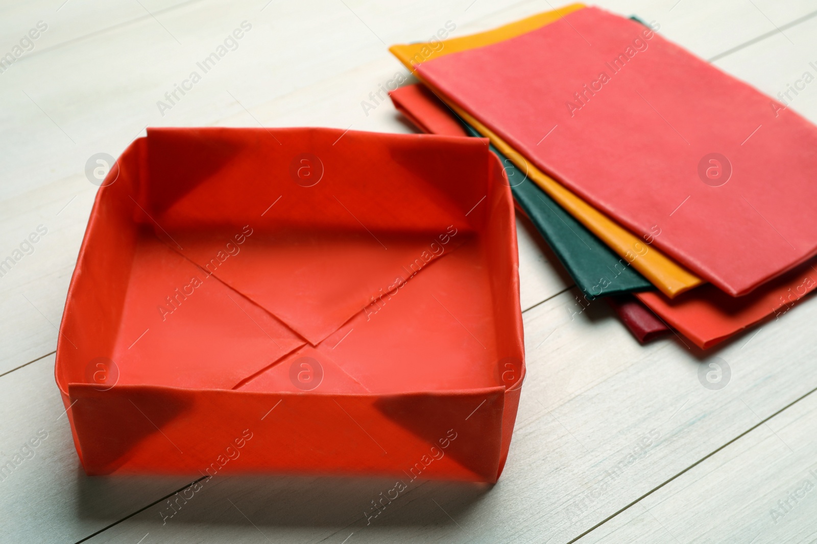 Photo of Box made of beeswax food wrap on white wooden table