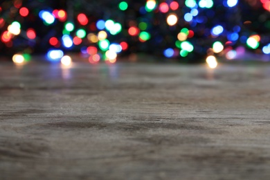 Wooden table and blurred Christmas lights on background