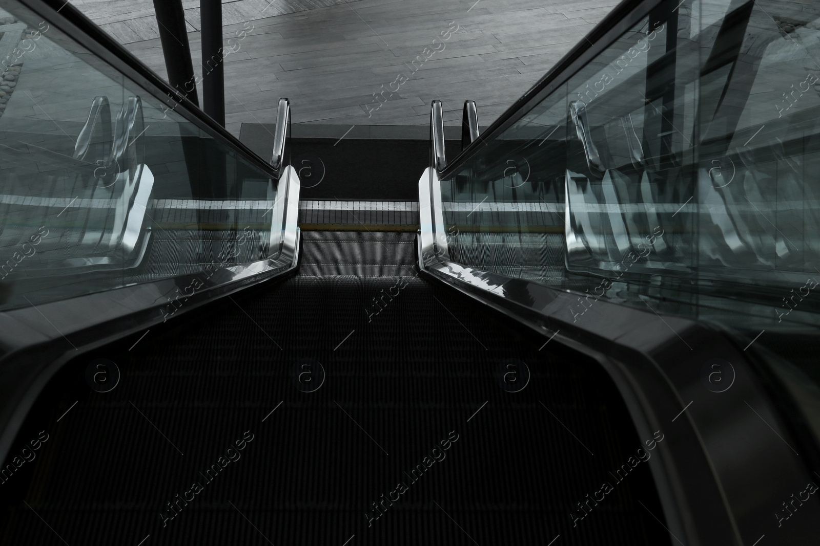 Photo of Modern escalator with metal handrails, above view