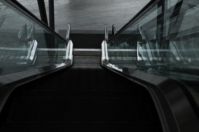 Photo of Modern escalator with metal handrails, above view