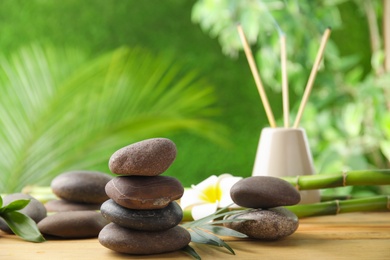 Photo of Composition with stones on table against blurred background. Zen concept