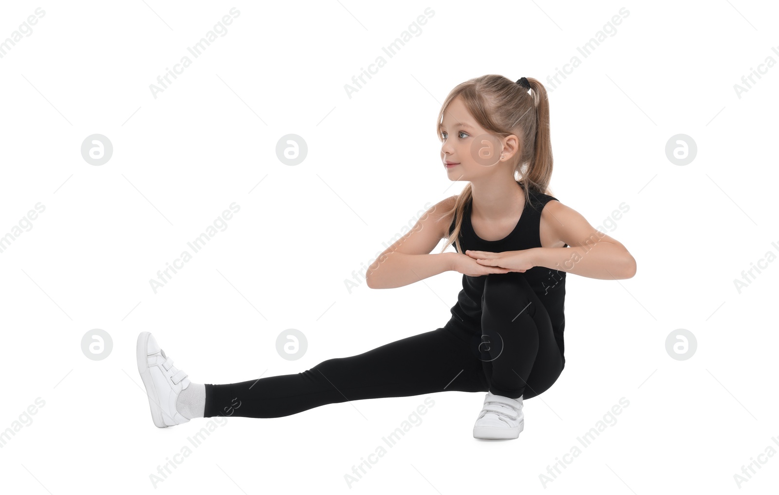 Photo of Little girl doing morning exercise on white background