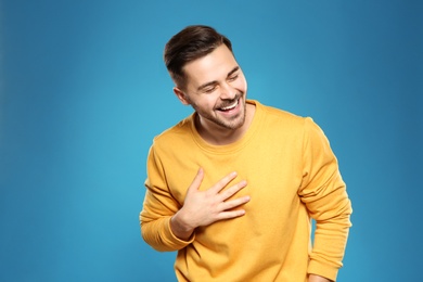 Photo of Portrait of handsome young man on color background