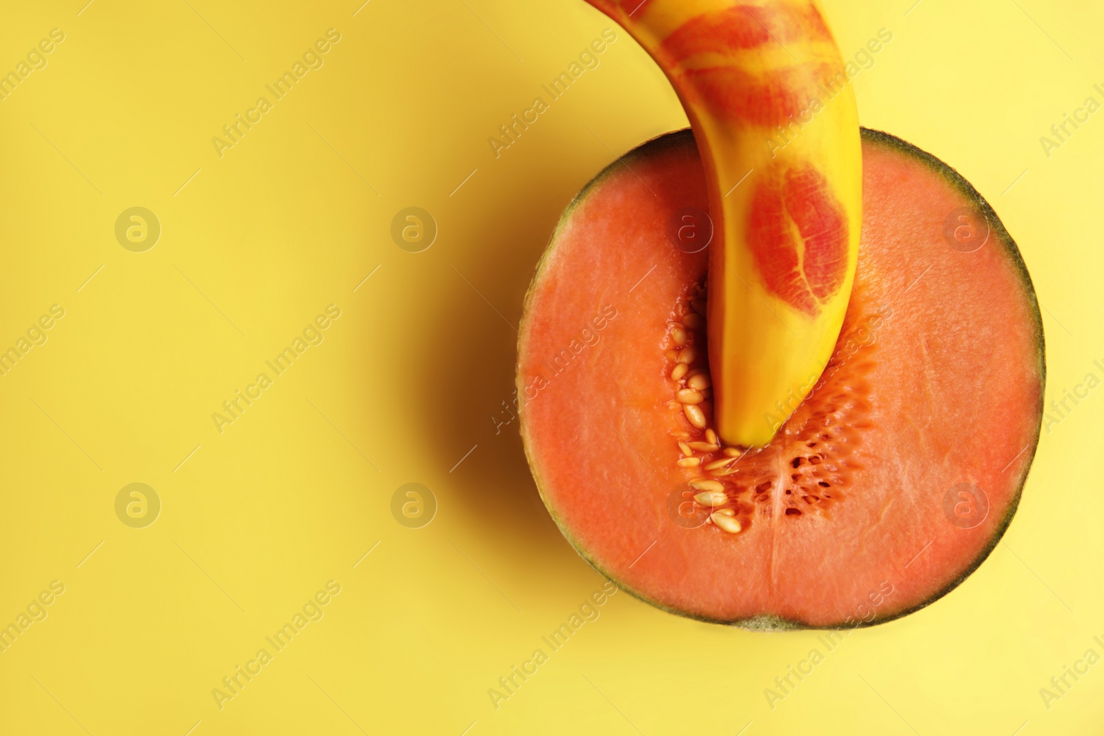 Photo of Flat lay composition with fresh banana and melon on yellow background, space for text. Sex concept