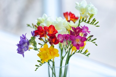 Beautiful bouquet with freesia flowers on blurred background