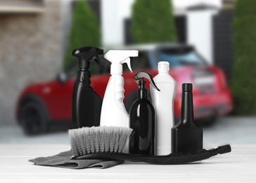 Image of Cleaning supplies on white wooden surface at car wash