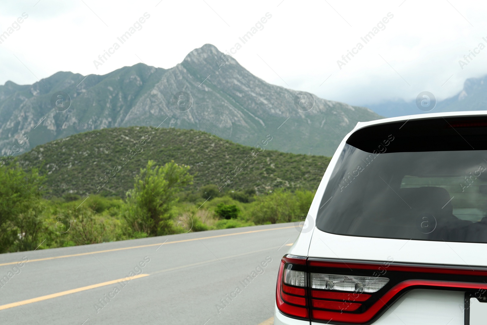 Photo of Beautiful view of car on asphalt highway in mountains. Road trip