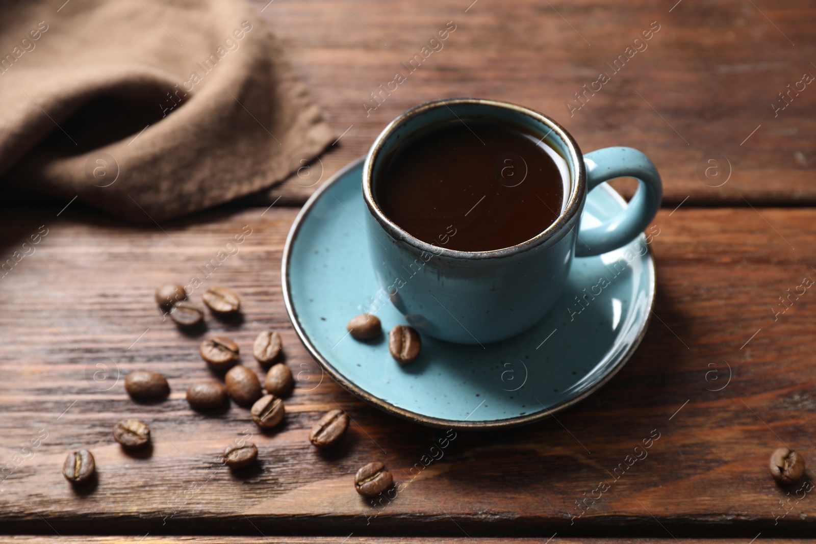 Photo of Turkish coffee. Freshly brewed beverage and beans on wooden table