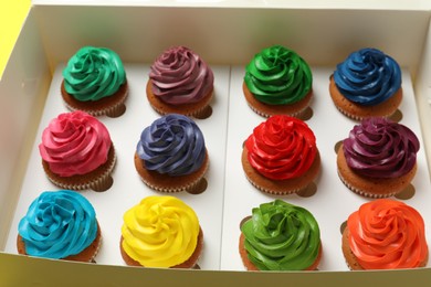Photo of Different cupcakes with cream in box, closeup