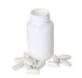 Bottle and pile of vitamin pills isolated on white