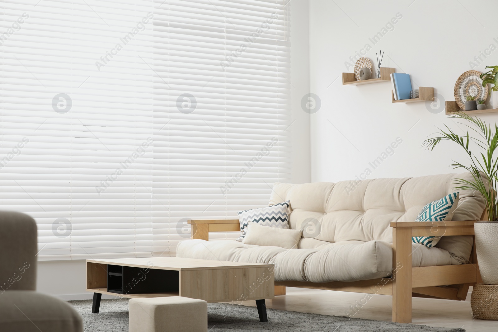 Photo of Stylish living room interior with comfortable sofa and side table