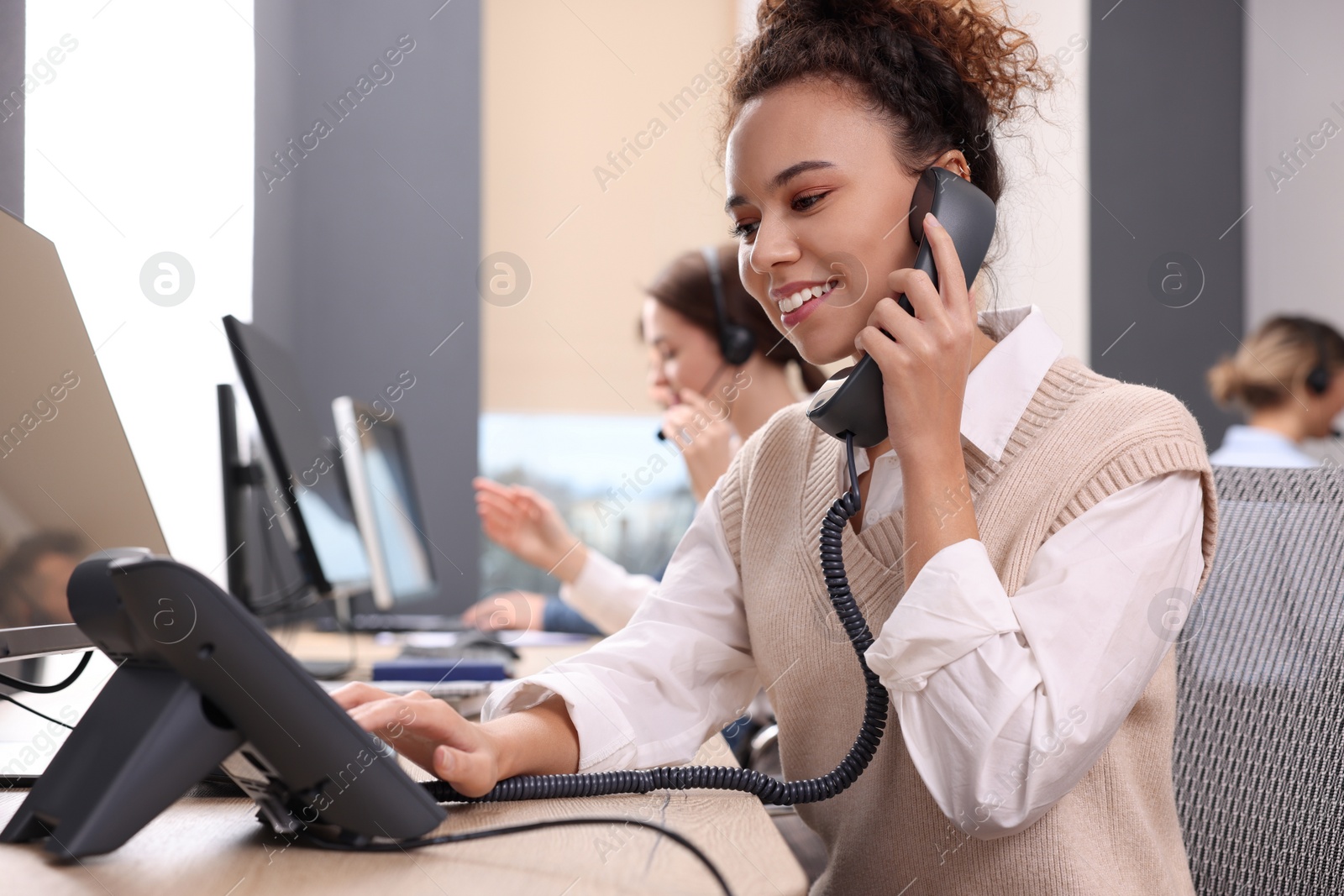 Photo of Call center operators working in modern office,