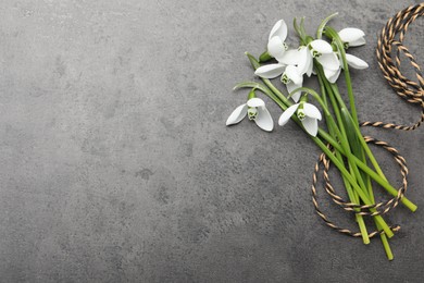 Photo of Beautiful snowdrops and twine on grey table, flat lay. Space for text