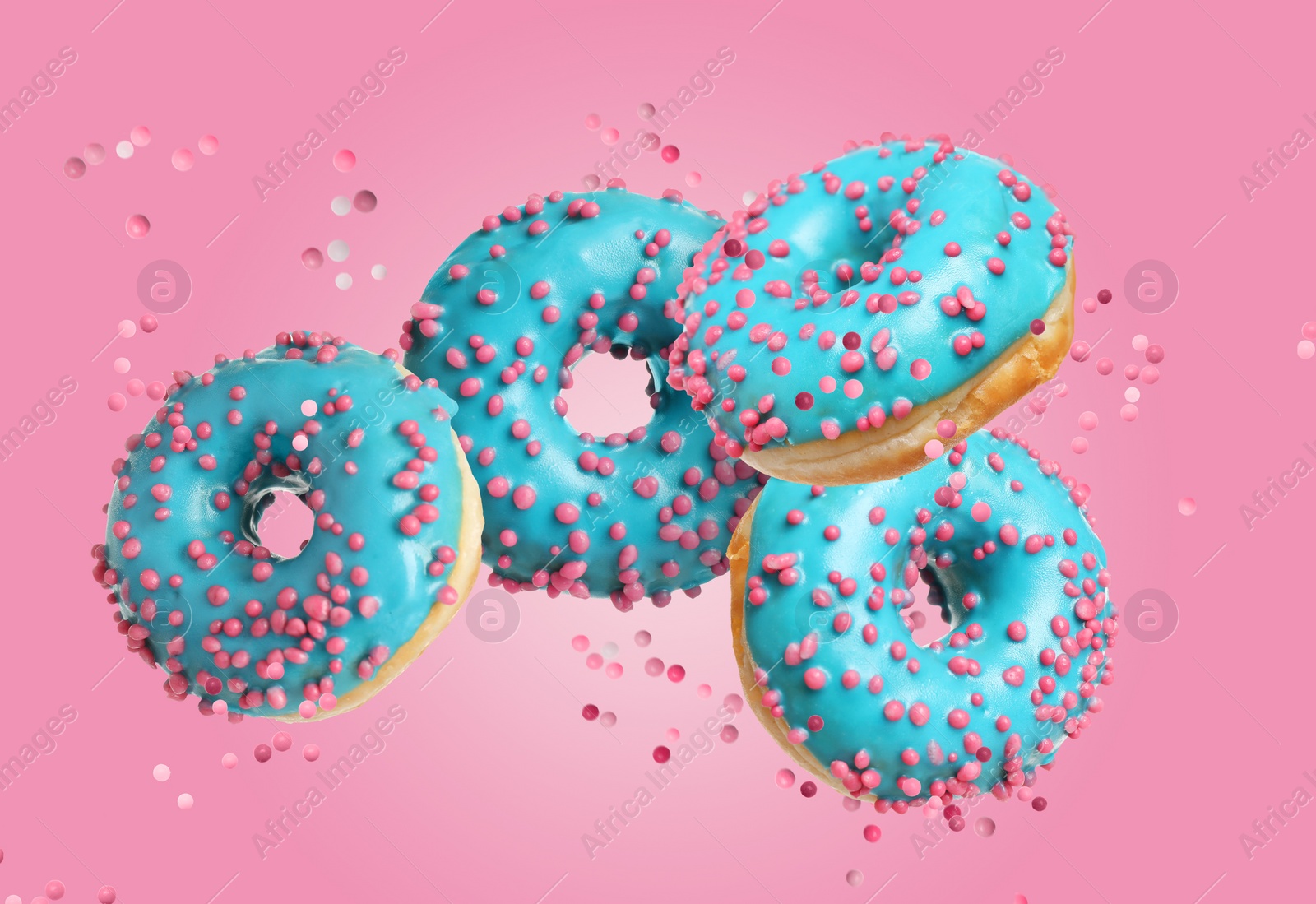 Image of Set of falling delicious donuts on pink background