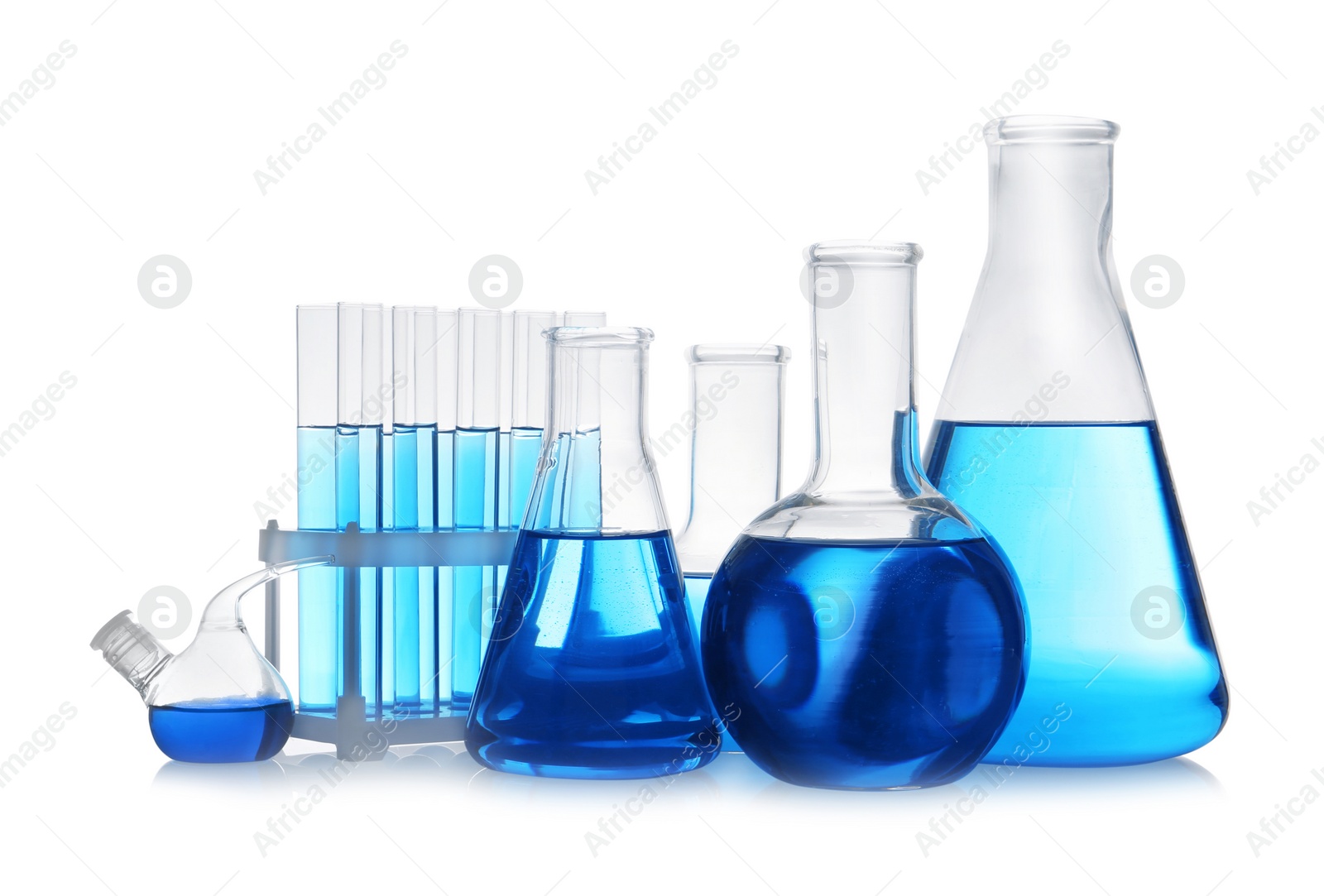 Photo of Set of laboratory glassware with blue liquid on white background