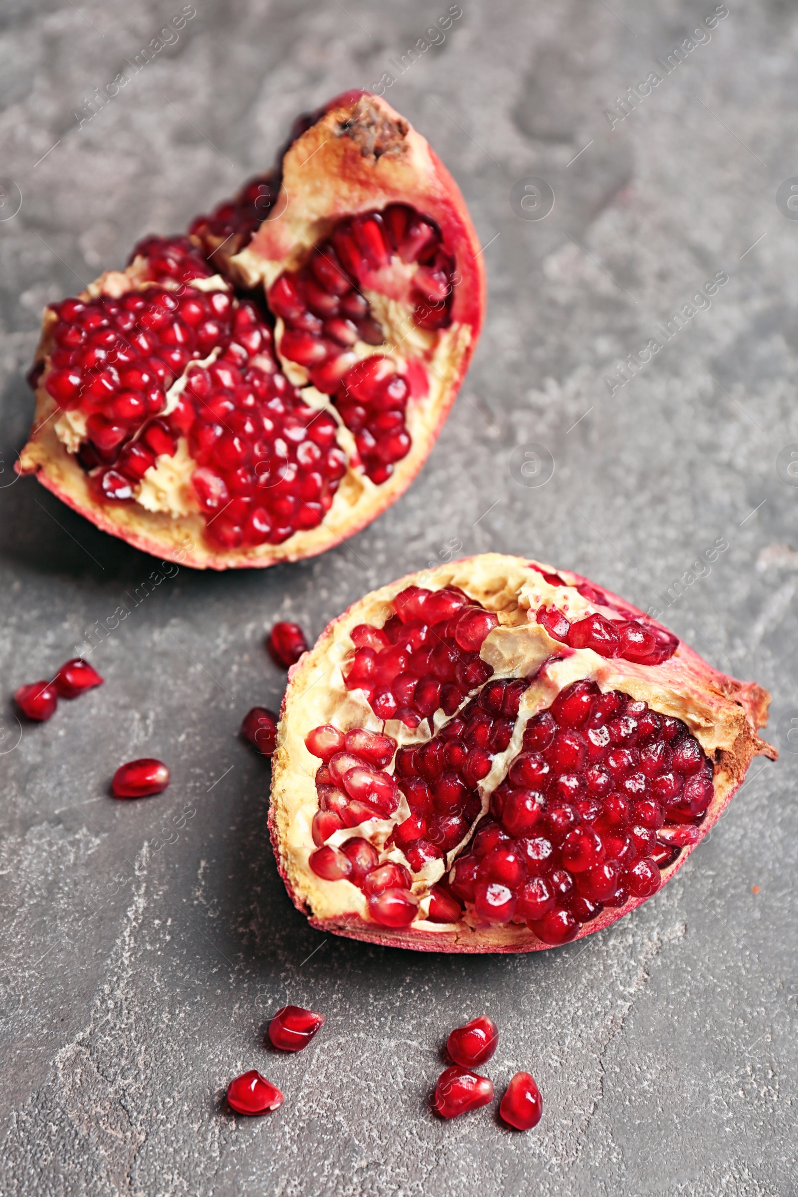 Photo of Fresh yummy pomegranate on grey table