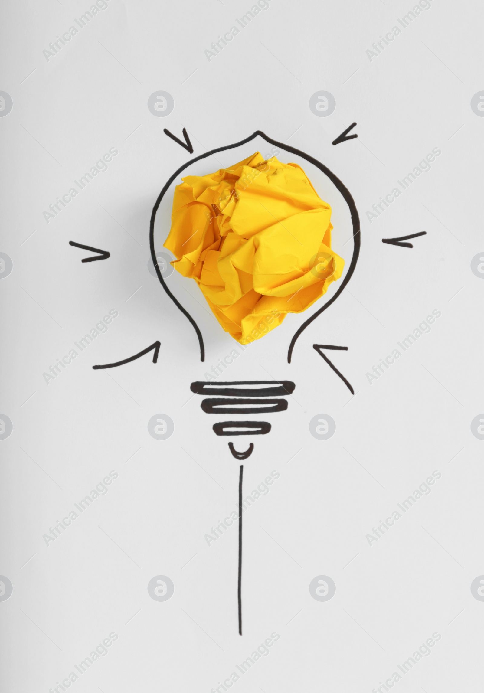 Photo of Composition with crumpled paper ball and drawing of lamp bulb on white background, top view. Creative concept