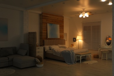 Photo of Stylish apartment interior with modern ceiling fan in evening