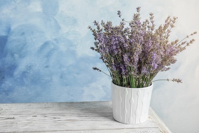 Photo of Pot with blooming lavender flowers on table